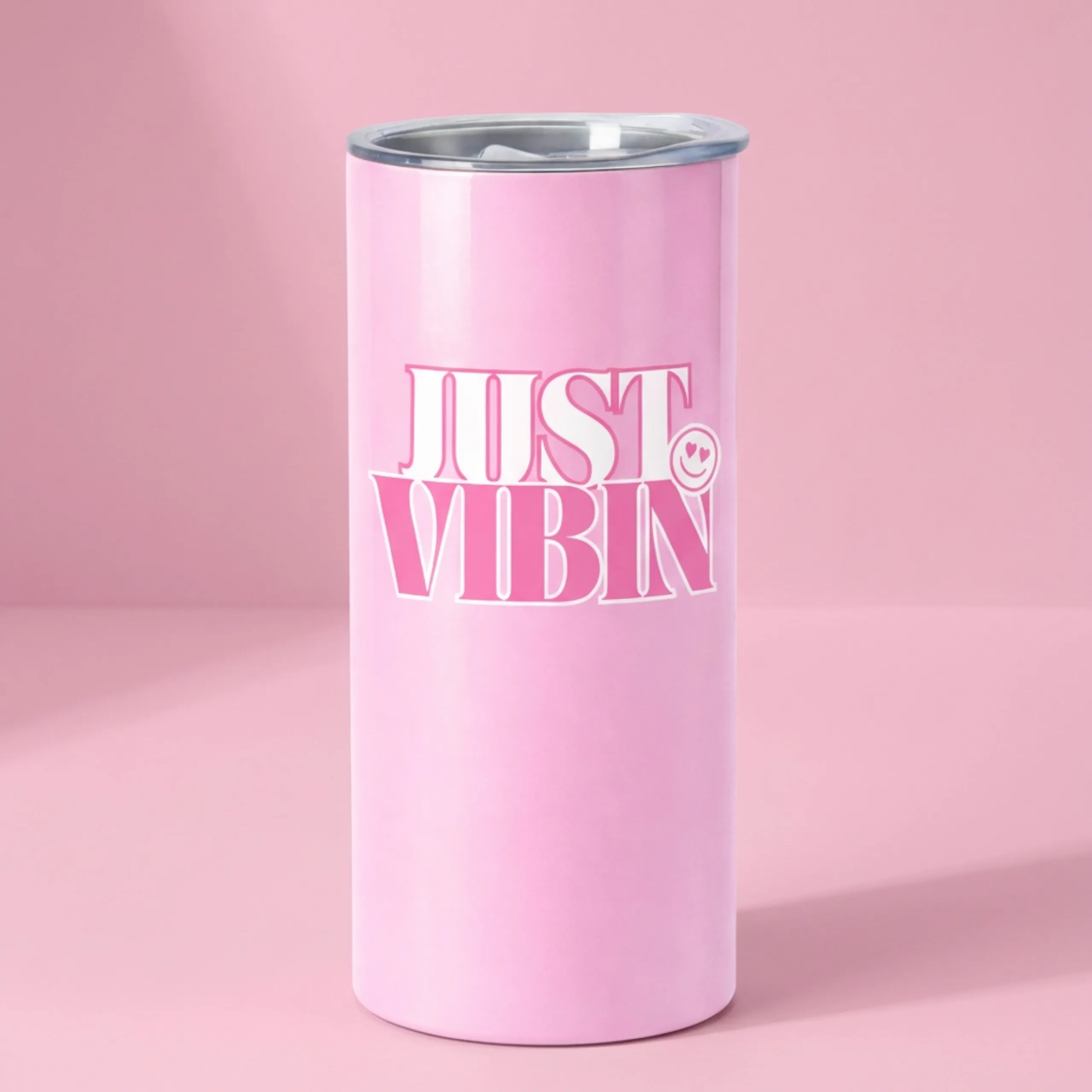 Pink “Just Vibin’” insulated tumbler with stainless steel lid on a soft pink background.